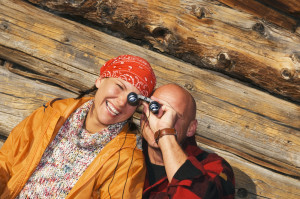 Couple at Smkoy Mountain cabins with view with binoculars