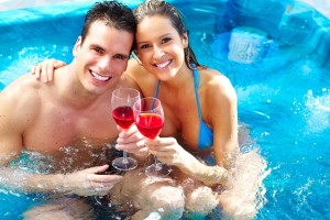 couple relaxing in outdoor hot tub at Smoky Mountain log cabins