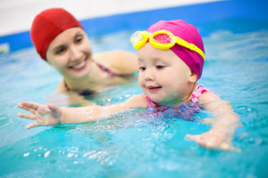 mom and daughter swimming at Smoky Mountain log cabins with swimming pool access